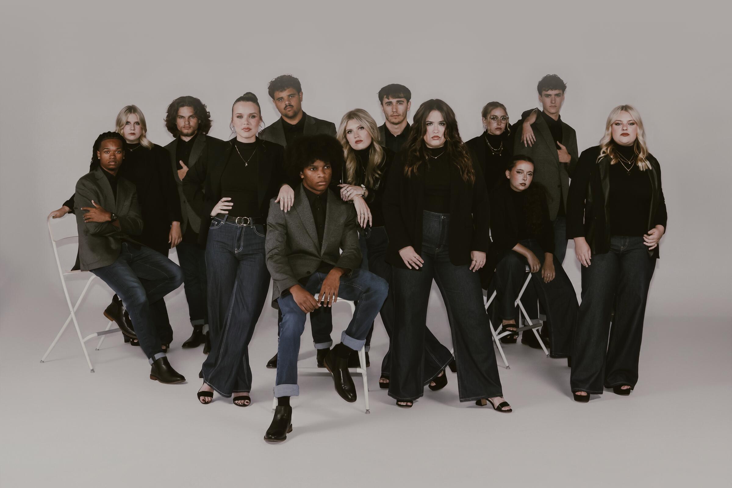 The members of Carolina Sound posed together in dark blazers and denim